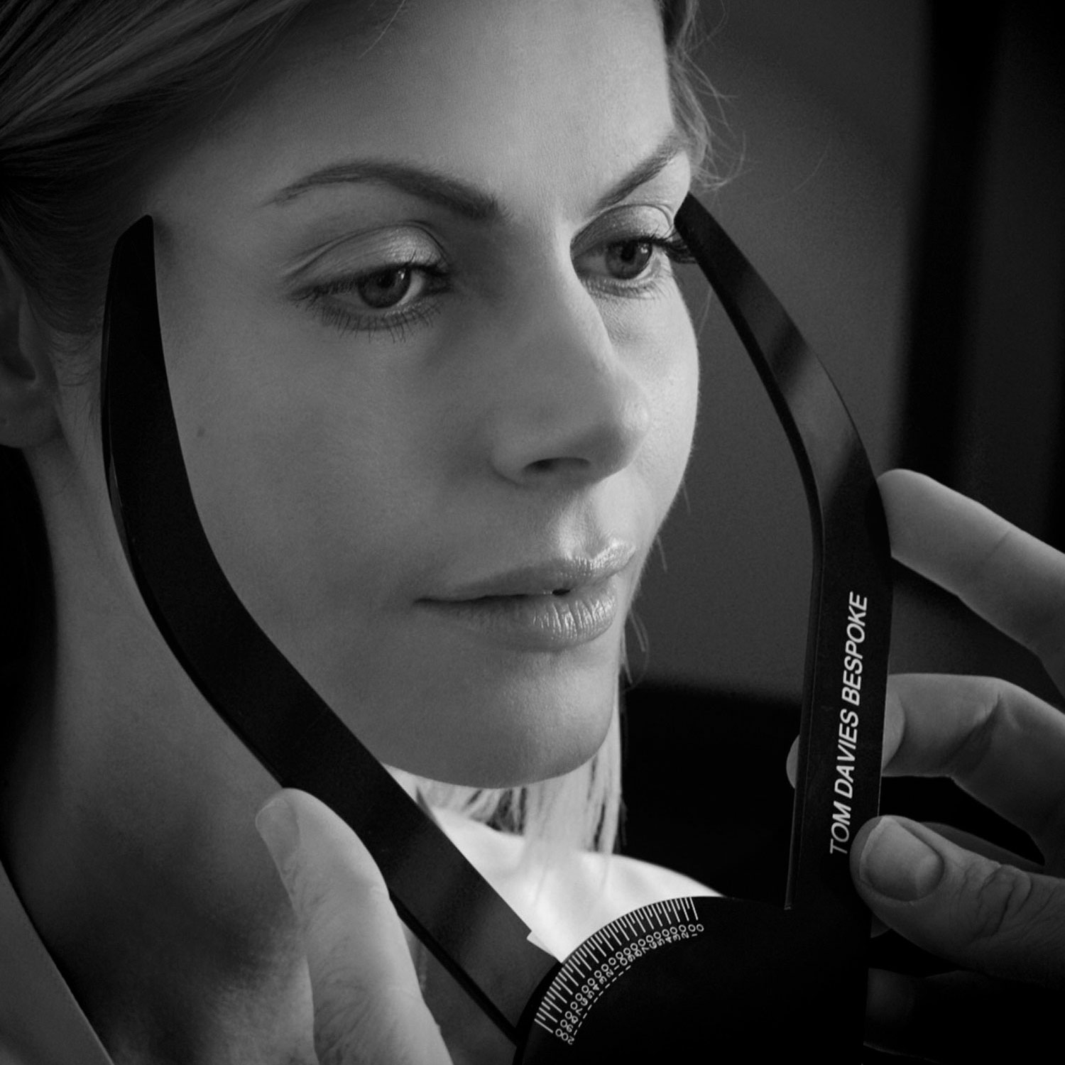 Customer having her facial measurements taken as part of the Tom Davies bespoke consultation