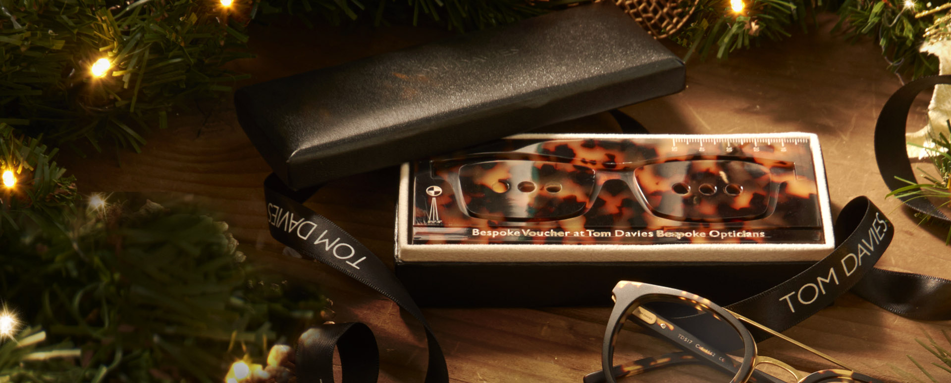 Tom Davies Bespoke Experience Voucher with gift box on dark background