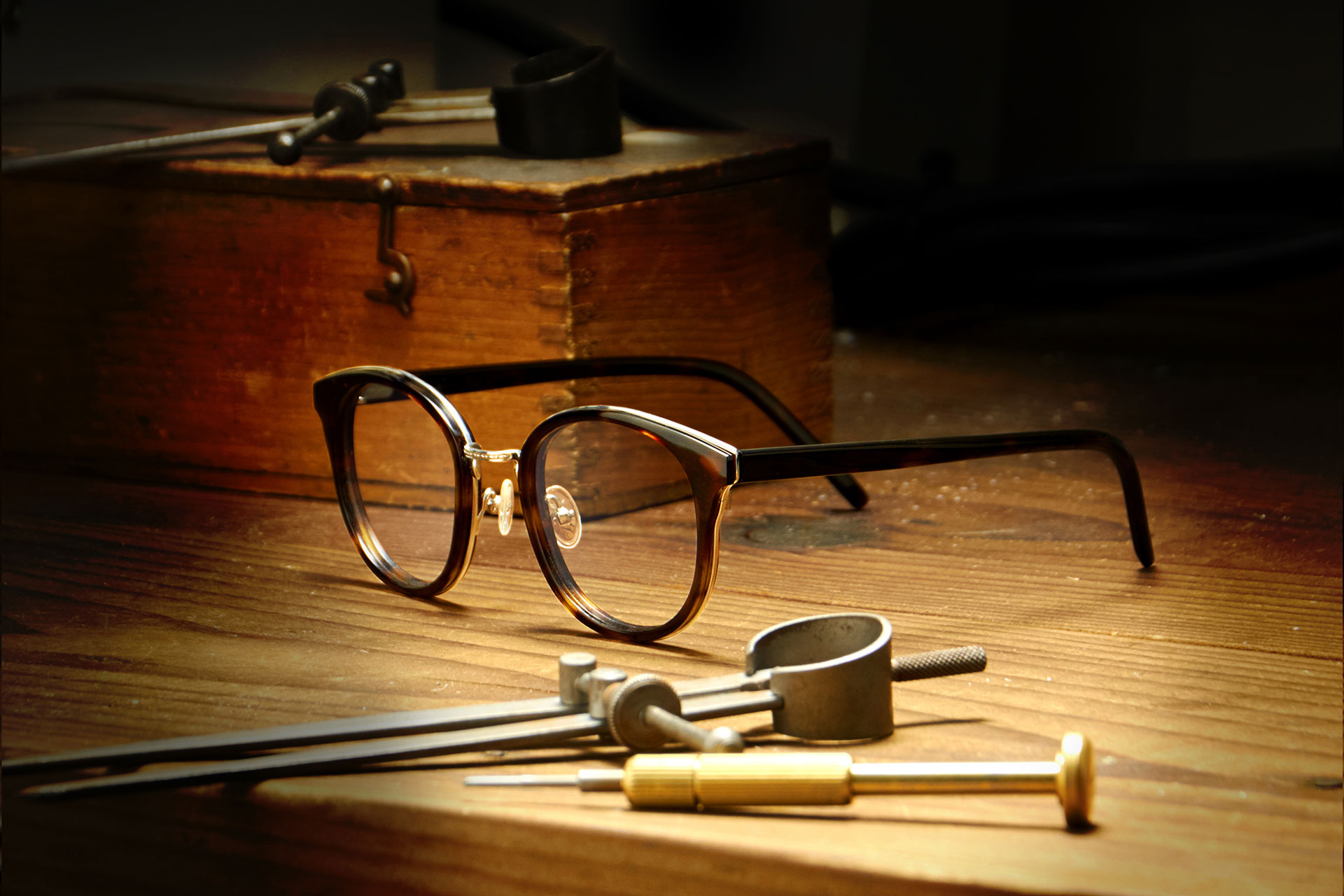 Tom Davies acetate frames and tools on wooden workbench in the brand's London factory