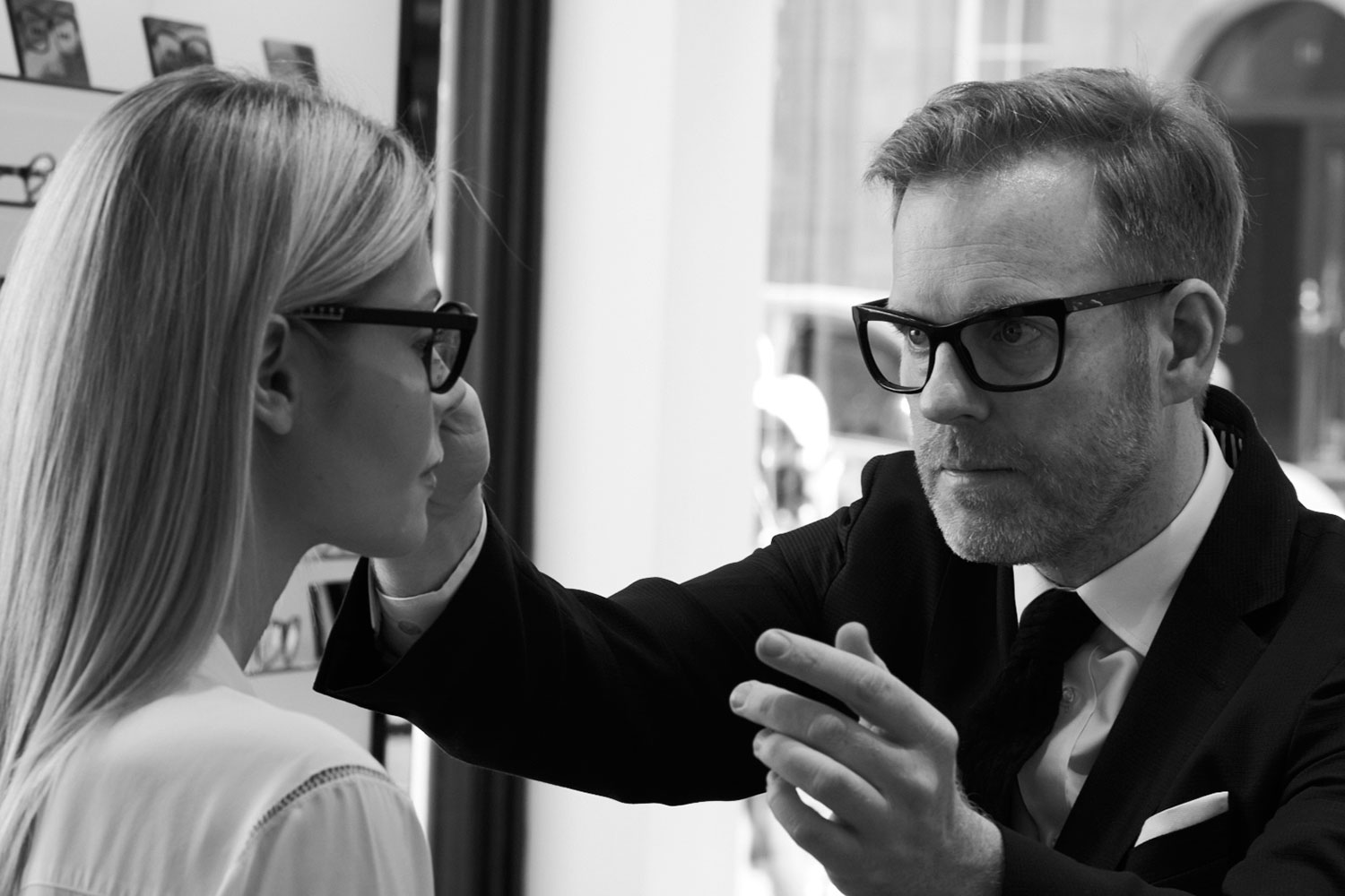 Bespoke eyewear designer Tom Davies during a bespoke consultation with a female customer