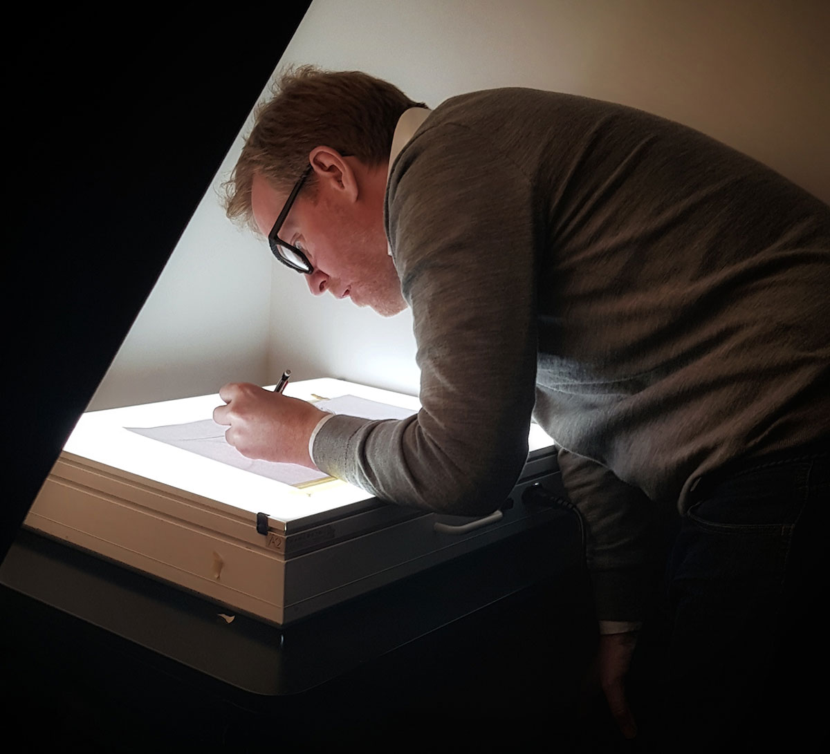 British eyewear designer Tom Davies sketching frames in his London design studio