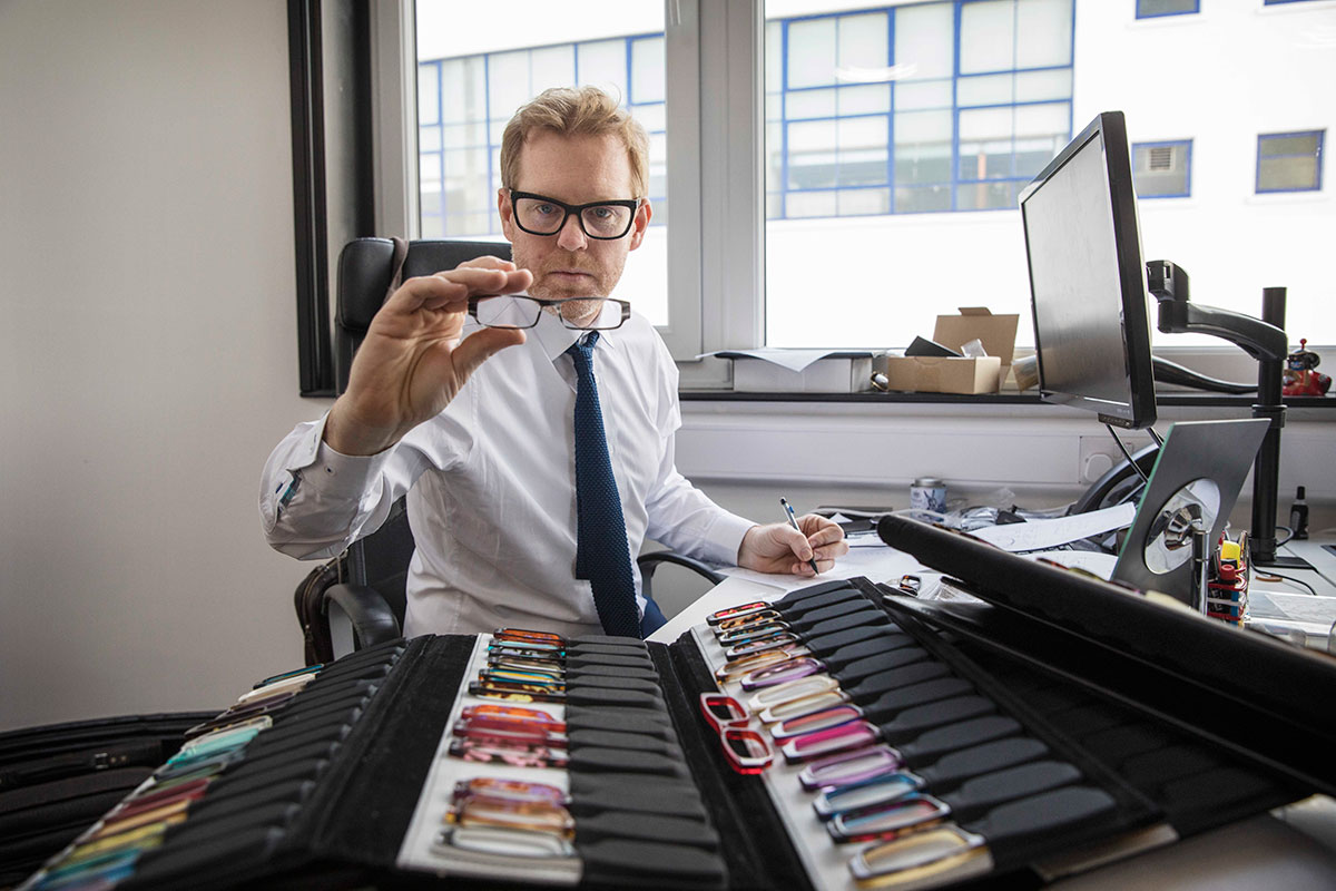 British eyewear designer Tom Davies examining acetate colour options in his London office