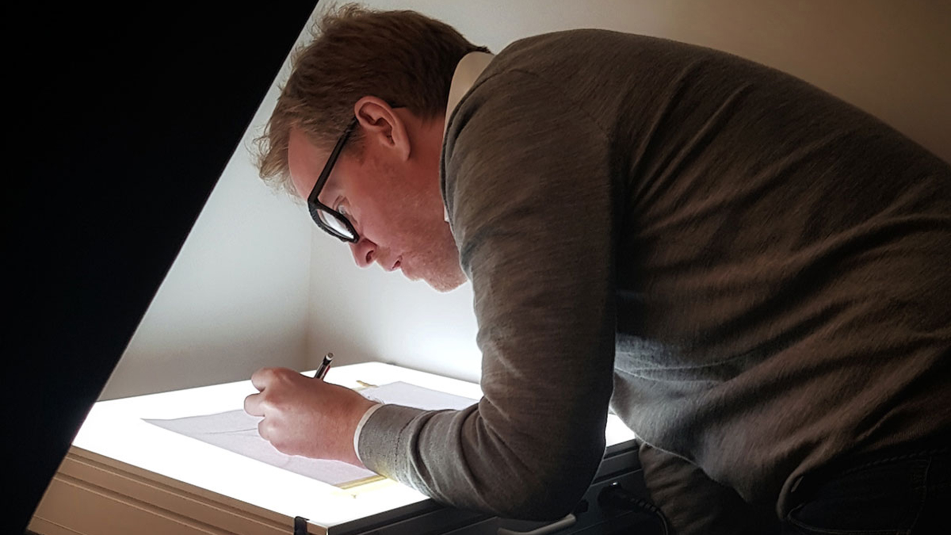 British eyewear designer Tom Davies sketching frames in his London design studio