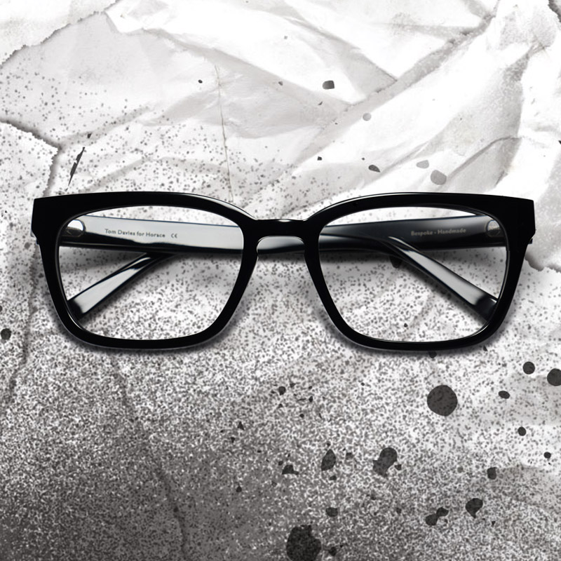 Paul Walter Hauser as Horace wears glasses in Disney's Cruella, designed by Tom Davies.